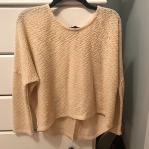 Tan sweater with button detailing on the back